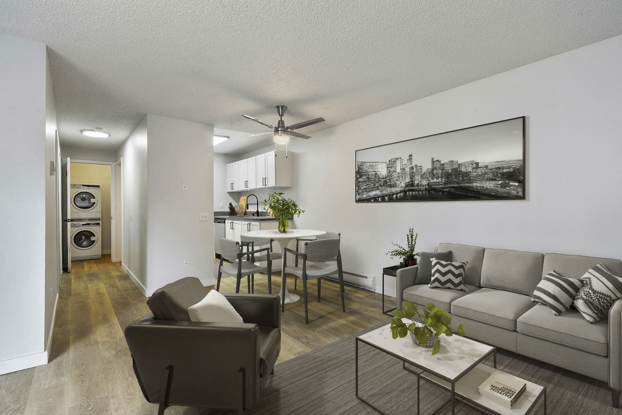 the living room of an apartment with a couch and a dining table
